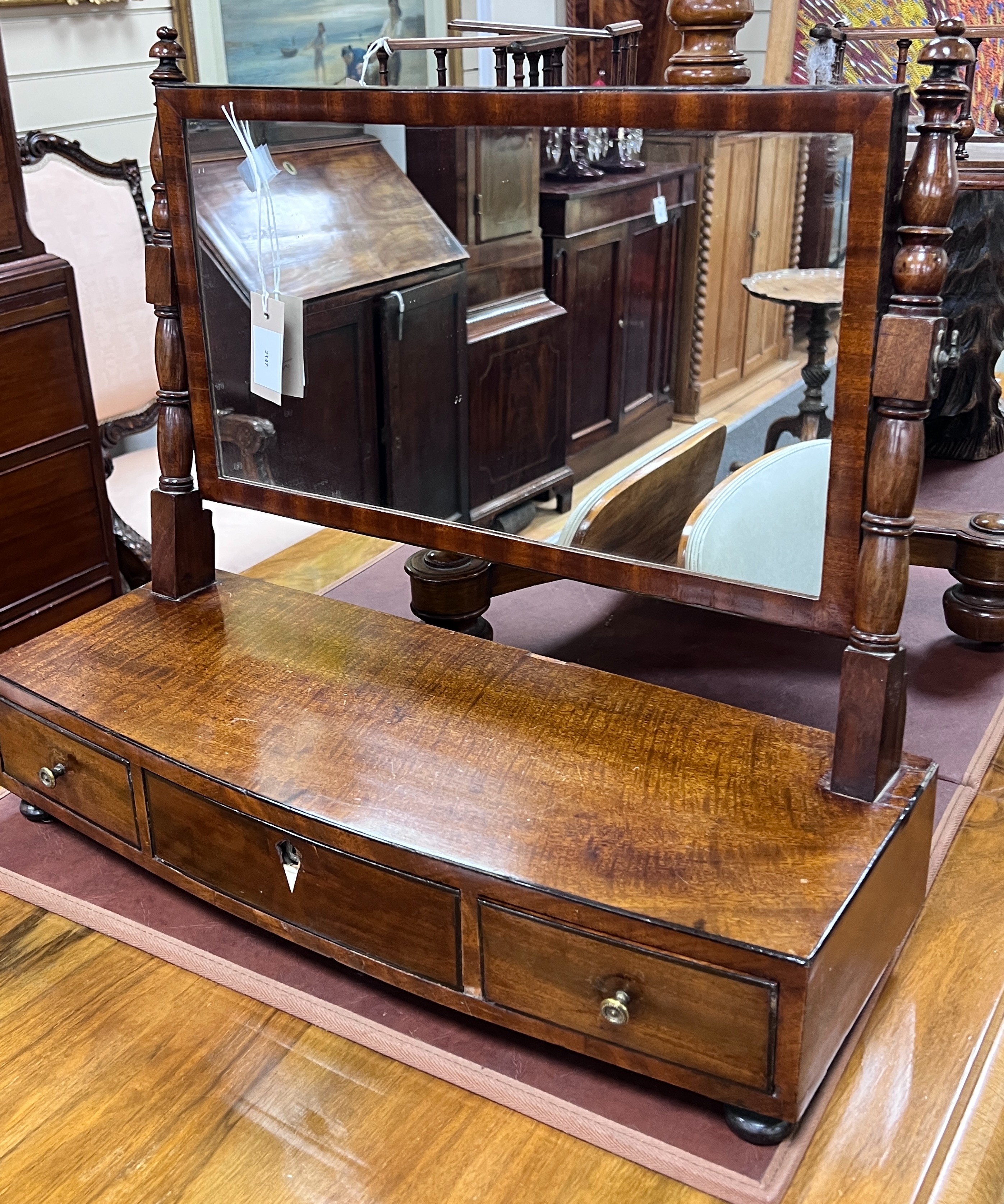 A Regency mahogany bow front box base toilet mirror, width 58cm, depth 23cm, height 51cm